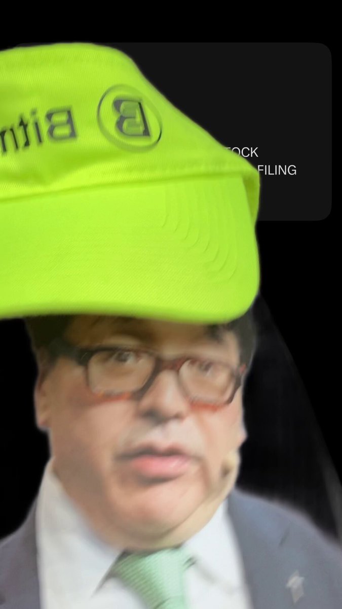 The image features a man wearing glasses, a white shirt, and a green tie with a yellow baseball cap tilted backwards over his head. The caption reads "POV - your @fundstrat and your offering yield on $BMNR cause it worked so well for @saylor".