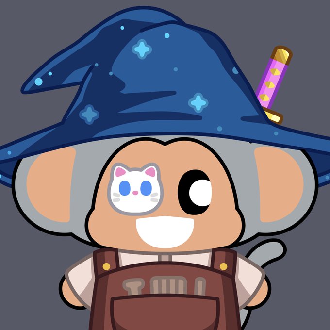 Cartoon mascot character wearing a blue wizard hat and brown overalls, featuring a small cat face design on its cheek.