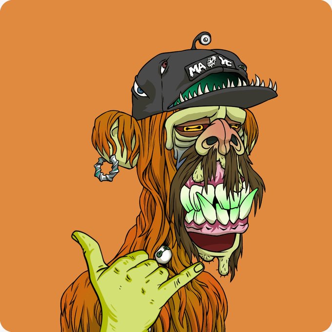 A cartoon illustration of a wild character with orange hair, a cap labeled 'MAYHEM', sharp green teeth, a mustache, and a hand making a gesture against an orange background.