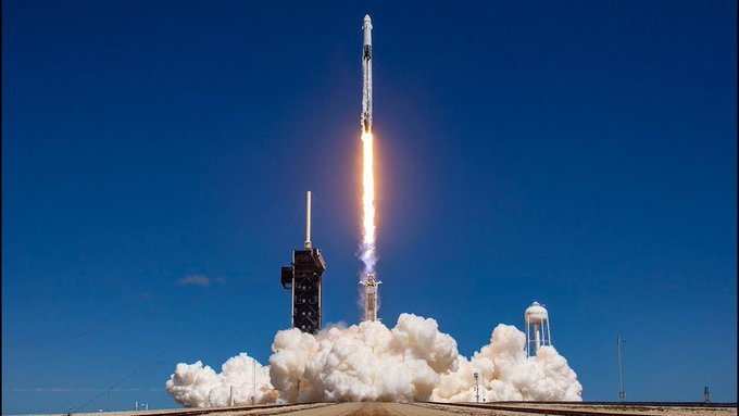 A rocket launches dramatically into a clear blue sky, leaving a trail of bright flames and billowing white smoke as it ascends from the launch pad. The image symbolizes the explosive upward momentum referenced in the post, visually reinforcing the idea of tokens like Robinhood and "Pons" reaching for the moon.