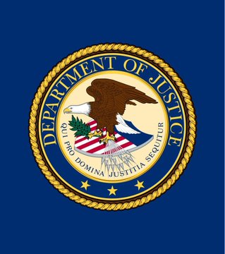 The image shows the seal of the U.S. Department of Justice, featuring an eagle, shield, and the motto "QUI PRO DOMINA JUSTITIA SEQUITUR," set against a dark blue background. This image relates to the post because it represents the DOJ, the agency currently reviewing whether Binance remains compliant with its 2023 settlement agreement.