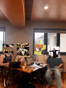 Three young men are gathered around a table with laptops in what appears to be a casual co-working space or café, with the leftmost person having "XIAO QIU" visible on his shirt, connecting to the post's reference to the eight-pack abs team member. The caption highlights how the team in the image embodies the post's message about modern essentials, showing them working together with technology while representing the fitness-minded, tech-savvy team described.