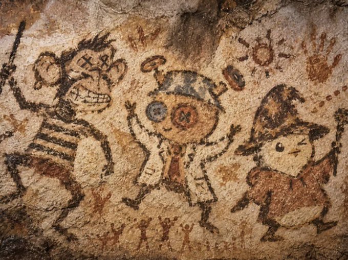 Three whimsical, child-like figures—a grinning monkey, a wide-eyed character with buttons for eyes, and a pointed-hat figure—painted in dark brown and ochre tones on a textured cave wall, alongside a small sun motif and tiny human silhouettes at the bottom. The artwork illustrates how NFT art can be preserved for millennia, as seen in the Bored Ape Yacht Club community member @wutaner's Project Oncave initiative.