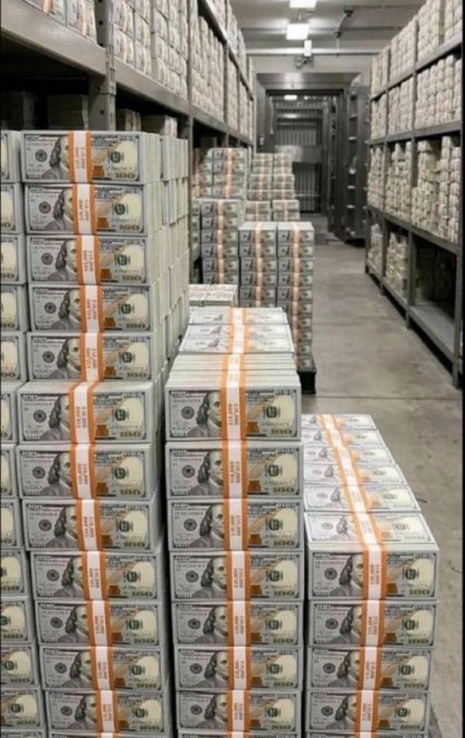 Stacks of bundled US $100 bills filling industrial storage shelves in what appears to be a vault or warehouse.