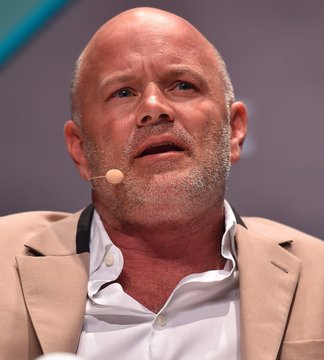Mike Novogratz, CEO of Galaxy, speaking at a conference with a headset microphone, discussing his prediction that the Clarity Act will pass with a last-minute compromise on ethics.