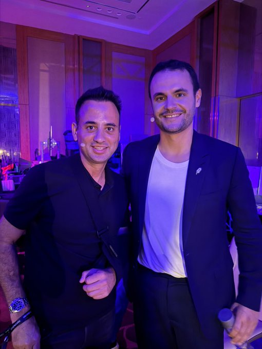 Two men, including Johann Kerbrat from Robinhood App, pose for a photo backstage before going live at the BingX stage for an interactive Q&A session with attendees.