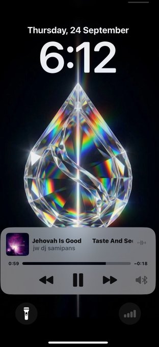 An iPhone lock screen showing Thursday, 24 September, 6:12, with a crystallized teardrop wallpaper and music playing 'Jehovah Is Good' by 'jw dj sampians'.