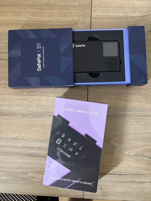 A SafePal S1 hardware wallet is shown in its open packaging, alongside a box for a Ledger Nano S Plus Ethereum edition, with the post discussing a transition between the two devices for storing crypto assets like $TAO while weighing Ledger's security concerns.