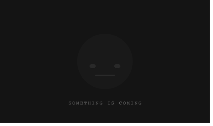A dark screen with a barely visible neutral face emoji and the text "SOMETHING IS COMING" below it.