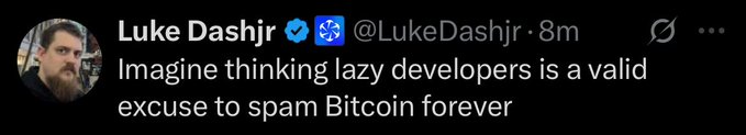 A screenshot of a tweet from Luke Dashjir (@LukeDashjir) reading: 'Imagine thinking lazy developers is a valid excuse to spam Bitcoin forever'.