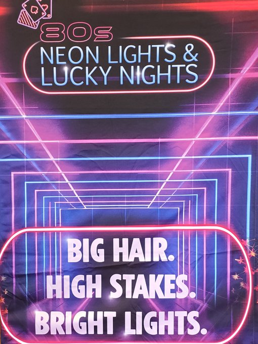 A vibrant 80s-style graphic featuring neon pink and blue lights with the text "80S NEON LIGHTS & LUCKY NIGHTS" and "BIG HAIR. HIGH STAKES. BRIGHT LIGHTS." evokes the retro aesthetic associated with the cryptocurrency ticker $MULLET. The design's nod to flashy 80s glamour ties directly into the playful, nostalgic vibe of the token's branding.