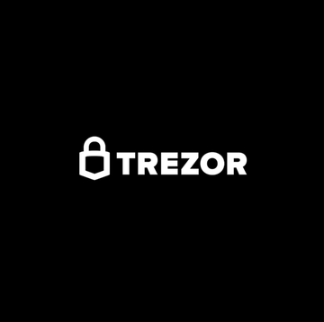 The image displays the white "TREZOR" logo with a padlock icon on a black background. The accompanying text notes that Trezor, a hardware wallet manufacturer, recently suffered a security breach at a logistics provider, exposing the personal data of over 13,000 customers.