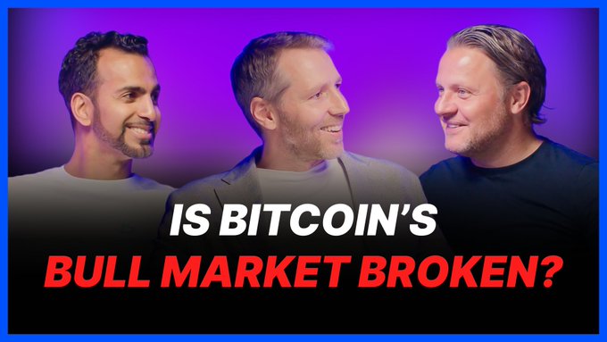 The image shows a group photo with three men, each wearing different colored shirts - white, black, and gray. The text "Is Bitcoin's bull market broken?" is written above them, and the caption below reads "Vol is muted, flows are stalled, and the crypto market is still not moving".