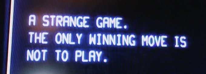 A close-up of a screen displaying the quote: “A STRANGE GAME. THE ONLY WINNING MOVE IS NOT TO PLAY.”