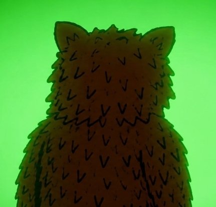 A dark, stylized illustration of a shaggy animal—possibly a bear or feline—rendered in black silhouette against a vibrant green background. The image’s ominous silhouette and bearish appearance metaphorically suggest that even in the face of bearish market forces, the XRP holder’s decade-long patience is about to pay off, countering the idea that their success was merely luck.