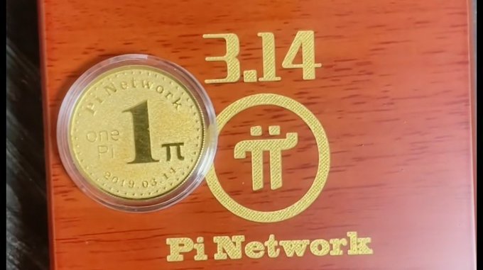 A commemorative gold Pi Network coin (dated 2019.03.14) marked '1 one Pi' sits beside its packaging which displays '3.14' and the Pi Network logo.
