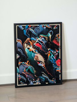 A framed abstract artwork with colorful figurative elements leans against a wall on a tiled floor.