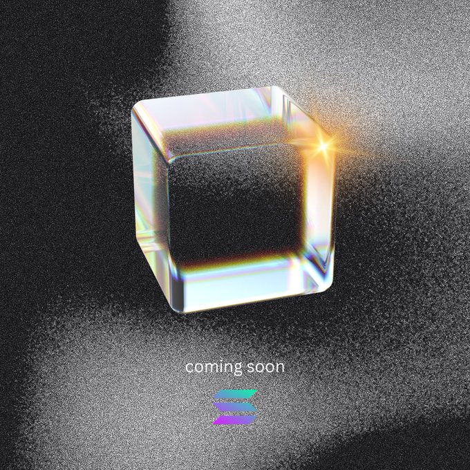 A promotional graphic showing a glowing glass cube with rainbow light refractions against a dark textured background, with the text 'coming soon' below it.
