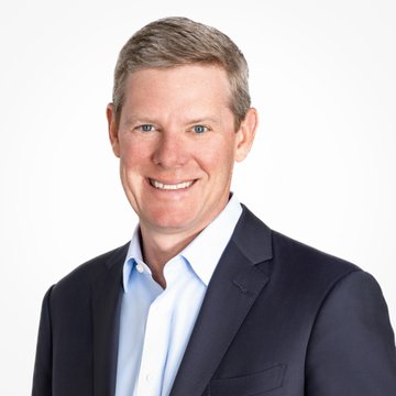 A professional headshot of a smiling man in a navy suit and light blue shirt, appearing to be Visa CEO Ryan McInerney, who is quoted discussing Visa's multi-coin, multi-chain strategy regarding stablecoins like Open USD, USDT, and USDC.