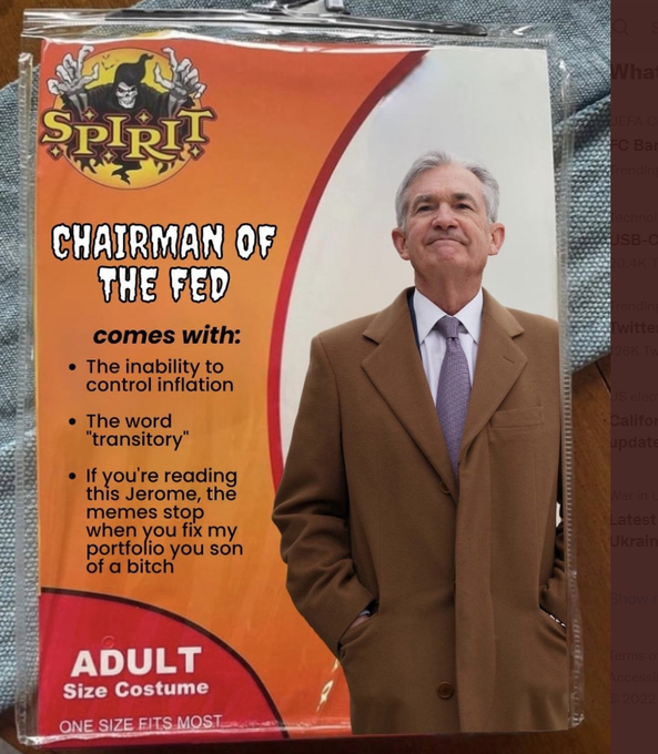 A 'Spirit' Halloween costume package labeled 'CHAIRMAN OF THE FED' featuring a man in a brown coat, with humorous features including 'The inability to control inflation' and 'The word "transitory"'.