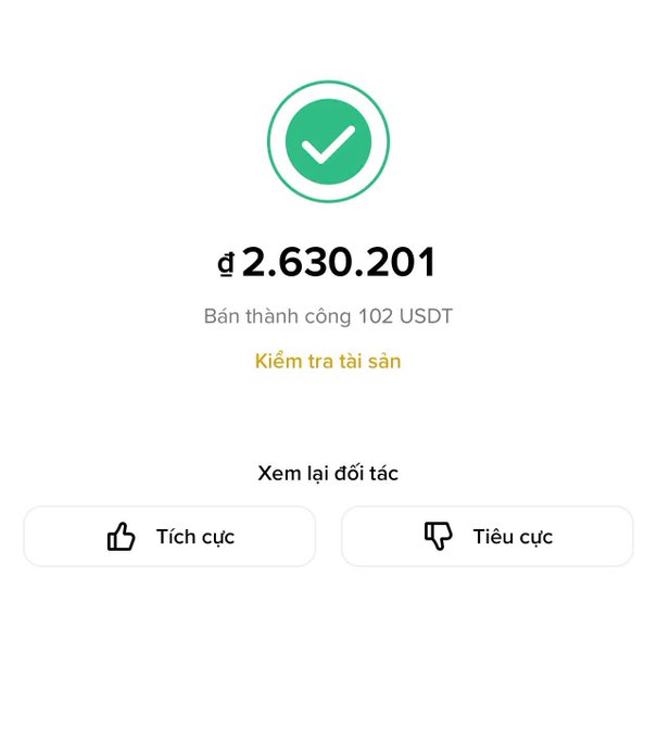 A successful crypto transaction confirmation screen showing a green checkmark, a sale of 102 USDT for ₫2,630,201, with options to check assets, view counterparty, and leave positive or negative feedback.