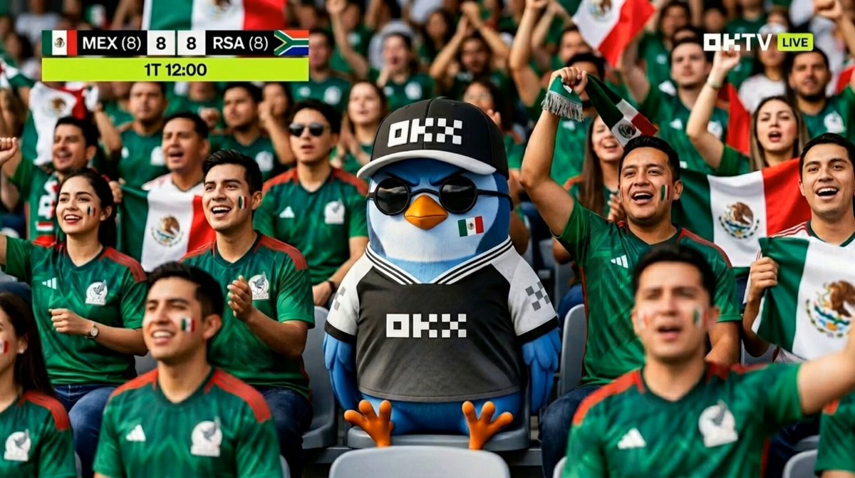 The image features a large group of people wearing green jerseys, with some of them holding flags. A mascot dressed as a blue bird is sitting among the crowd, drawing attention from the fans. The post includes text that reads "这个视频太抽象了 #OKX世界杯". This suggests that the image might be related to an event or gathering where the mascot and the fans are involved, possibly a sports game or a similar occasion.

The crowd in the image is diverse, with people of different ages and genders present. Some individuals appear to be wearing sunglasses, adding to the festive atmosphere. The overall scene conveys excitement and enthusiasm as the fans cheer on their team or mascot.