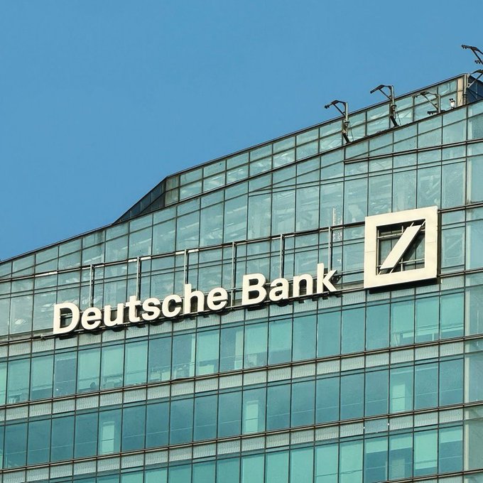 A Deutsche Bank building's facade is shown, prominently displaying its name and logo. The image illustrates the news that Germany's largest bank is expanding into cryptocurrency custody services for Bitcoin and Ethereum.