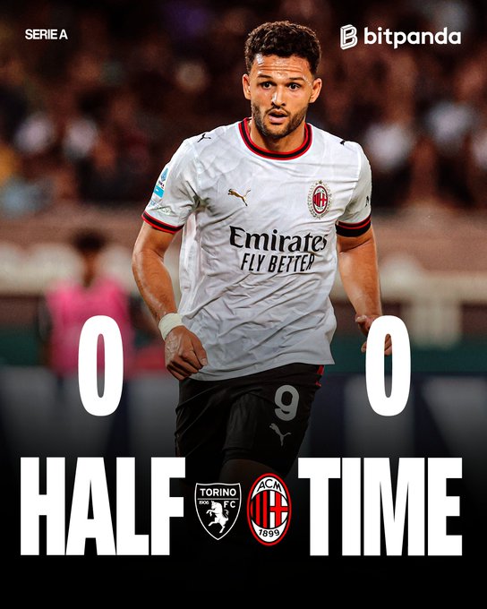 The image is a Serie A halftime graphic showing a 0-0 scoreline between Torino FC and AC Milan, featuring an AC Milan player wearing the number 9 jersey with the "Emirates FLY BETTER" sponsor logo. The "SERIE A" and "bitpanda" branding appears at the top, while the Torino and AC Milan (1899) club crests flank the bold "HALF TIME" text at the bottom, matching the post's message about a goalless first half brought to you by Bitpanda.