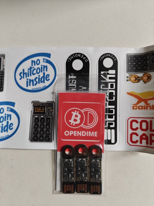 A sticker sheet featuring crypto-themed designs including "no shitcoin inside" stickers, a calculator, an OpenDime Bitcoin device, and "COIN CAP" text.