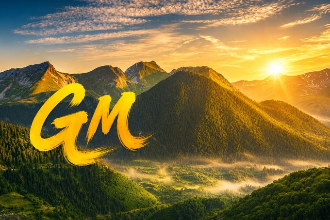 A bright 'GM' text in golden brush strokes is overlaid on a serene mountain landscape at sunrise.