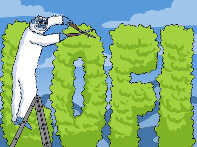 A person in a furry white cat costume stands on a ladder trimming topiary bushes shaped into tall letters, possibly spelling a word, against a cloudy sky.