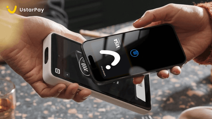 A person using a smartphone to make a contactless Visa payment via UstarPay on a payment terminal held by another person.