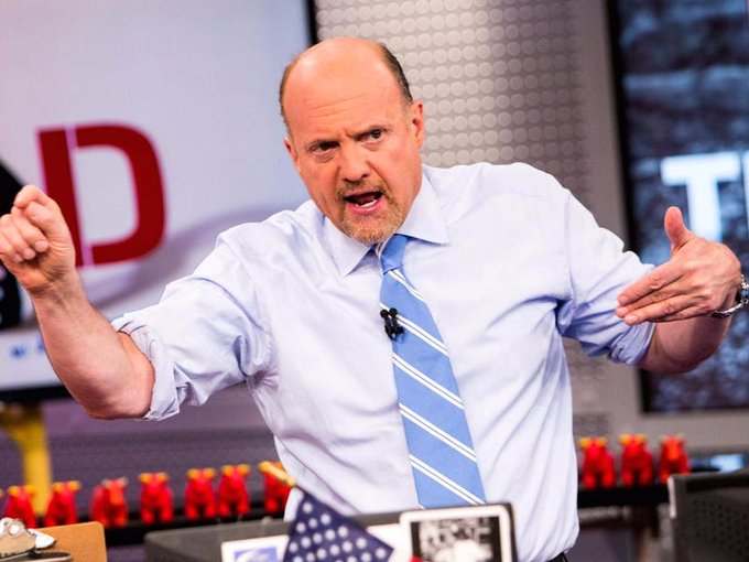 A bald man with a goatee, wearing a light blue shirt and striped tie, gestures emphatically with both arms while speaking on a TV studio set featuring the "MAD" logo. The image pairs with the post to highlight Jim Cramer as a notorious contrarian indicator, with his August 3rd call to sell Bitcoin coinciding with Bitcoin's subsequent surge to $78,000 by August 21st.