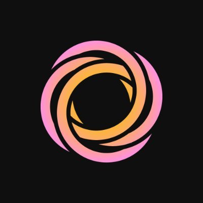 A stylized circular logo featuring swirling orange and pink/coral shapes against a black background, resembling a dynamic abstract emblem or vortex. The accompanying text discusses Lace (a Cardano wallet) integrating Keystone hardware wallet support, though the colorful abstract design itself does not contain any readable text, branding, or identifiable cryptocurrency symbols.