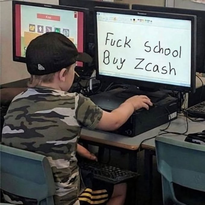 A meme photo of a young child in a backwards cap and camo shirt sitting at a computer in a classroom, with handwritten text on the monitor reading 'Fuck School Buy Zcash'.