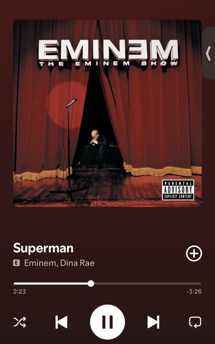 The image shows a Spotify playback screen for Eminem's "Superman" featuring Dina Rae from *The Eminem Show* album (with Parental Advisory label), currently paused at 2:23 of the 3:26 track. The lyrical quote "So everybody, just follow me..." ties into the promotional post for $LUKE, using Eminem's commanding lyrics to encourage investors to follow along as the token approaches 4000 holders.