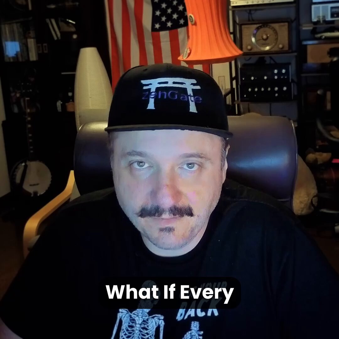 In this image, a man wearing an American flag hat with "ZenGates" printed on it is sitting down at his computer. The background features a lamp and various objects that suggest a home or office setting. Above him, there is a poster of a skeleton in red and white colors. In the corner of the room, there is also a clock hanging on the wall.