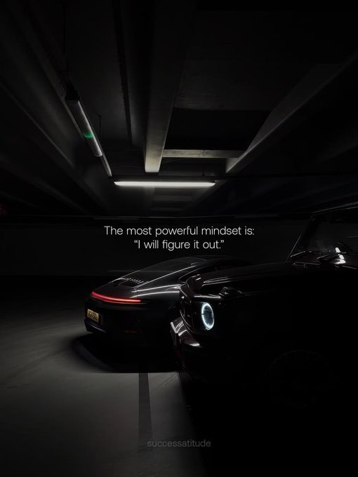 The image shows two sleek, dark cars, one with illuminated taillights and the other with a glowing headlight, set