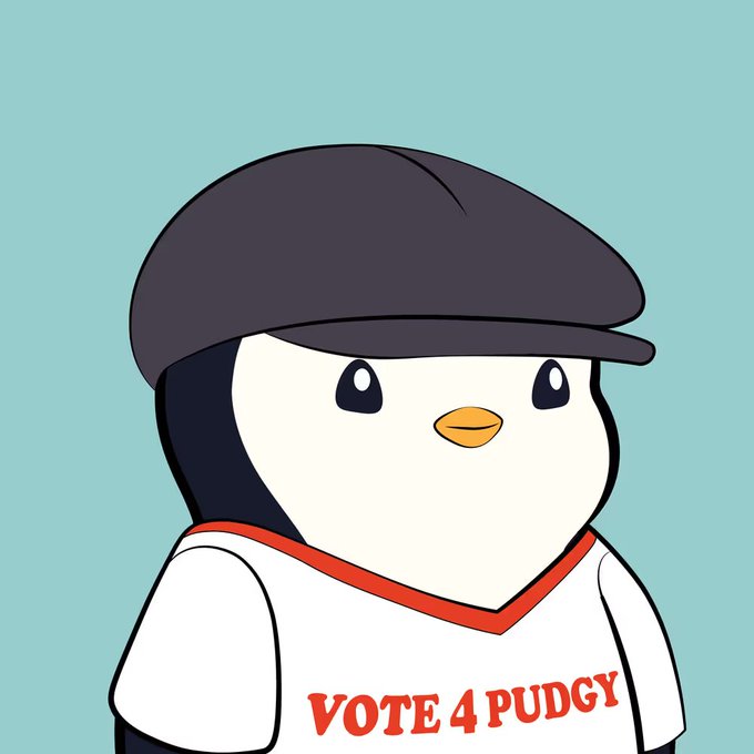 A cartoon penguin wearing a dark cap and a white shirt with red trim; the shirt reads “VOTE 4 PUDGY.”