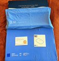 A small blue fabric organizer laid flat, containing a few small cards and papers.