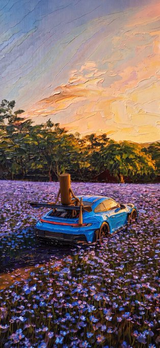An artistic image shows a blue sports car parked in a field of purple flowers with an orange cat sitting on its spoiler at sunset.