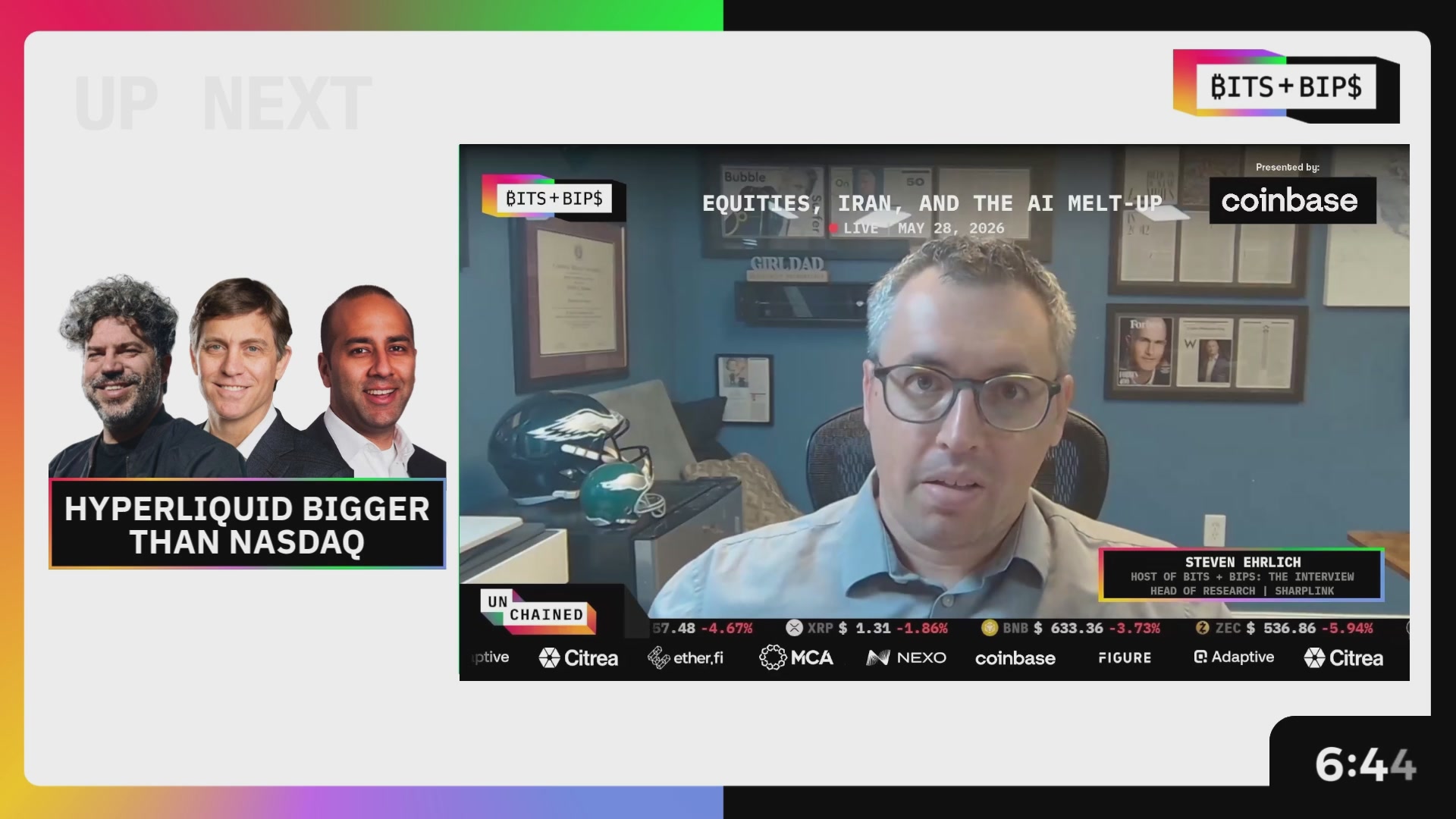 The image shows a television screen displaying three men sitting behind a desk with their backs turned towards the camera. The first man has short hair and is wearing glasses, while the other two have longer hair and are smiling at the camera. In front of them on the screen, there is text that reads "MSTR, HYPE, Dimon vs. Armstrong, and the Safety of DeFi". This suggests that they might be discussing a recent news story or event related to cryptocurrency trading or blockchain technology.