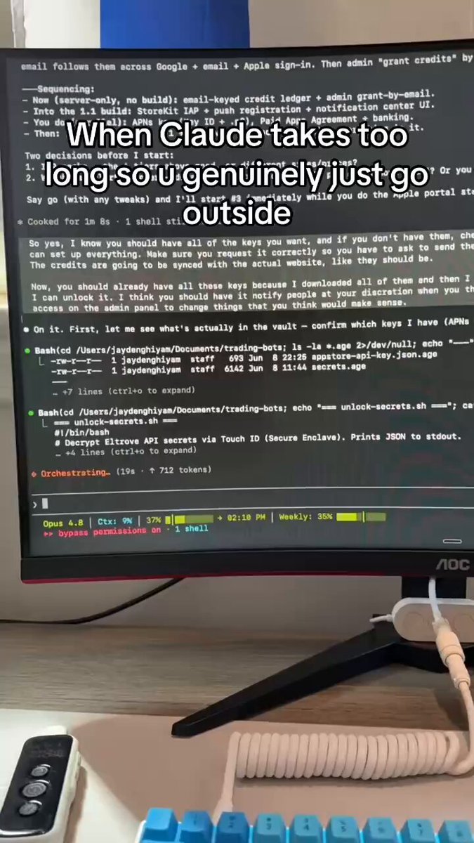 A computer monitor displaying lines of code sitting atop a desk with a keyboard to its right. The monitor shows an error message on it and appears to be written by someone named claude-bughunter, who was turned into a bug bounty system by exploiting a vulnerability in their code.
