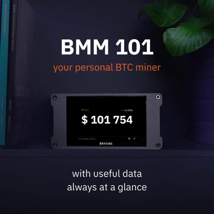 The image shows an electronic device, likely a computer or tablet, with a screen displaying Bitcoin mining information. The text on the screen reads "BMM 101 your personal BMTc miner". Below this, there are instructions for starting a solo mining session from one's desk.