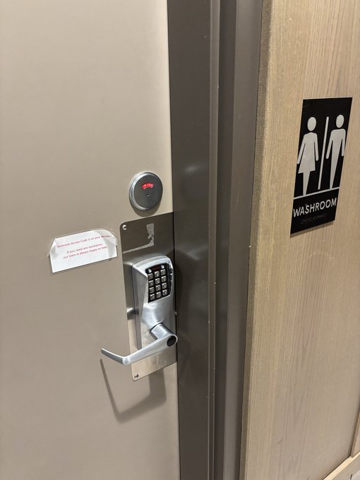Photo of a restroom door with a keypad lock, a red unlock indicator, a 'Washroom' sign, and a small notice about leaving the door locked.