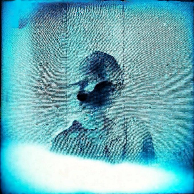 A cyanotype-style blue print depicting a faint silhouette of a figure against a textured background.