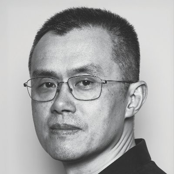 A black and white portrait photo of a middle-aged man wearing glasses against a plain light background.