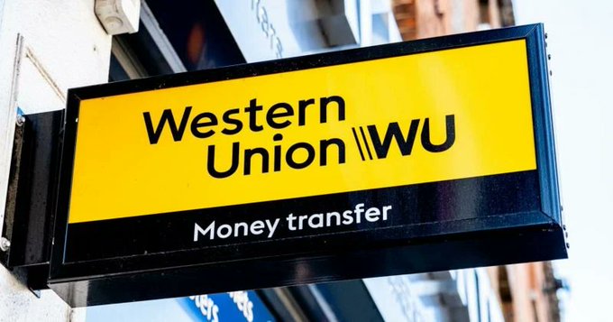 A yellow and black storefront sign for Western Union (WU) reading 'Money transfer.'