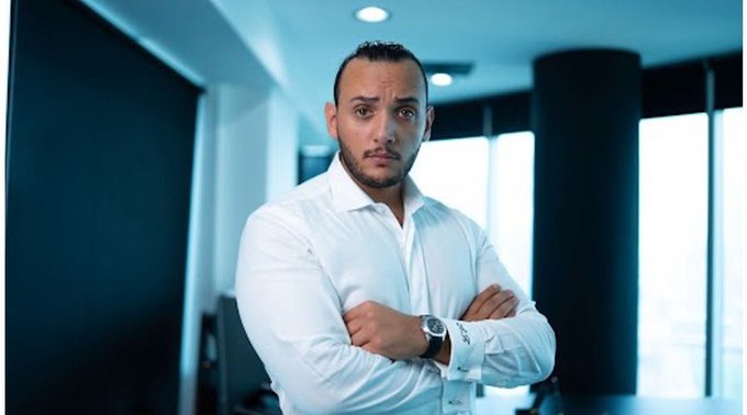 A man in a white dress shirt with his arms crossed is pictured, possibly promoting the $20,000 account giveaway mentioned in the accompanying text from @Khldfx.