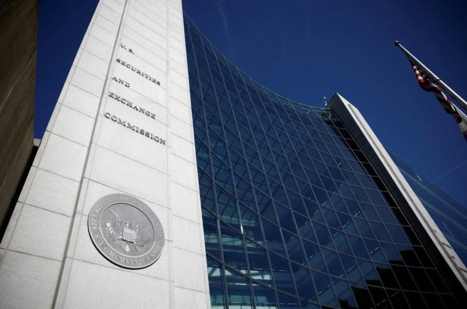 The image shows the U.S. Securities and Exchange Commission headquarters building, featuring a stone facade inscribed with "U.S. SECURITIES AND EXCHANGE COMMISSION" alongside the agency's official seal, with its modern glass-and-steel structure rising in the background. This connects to the post's mention of the SEC's Thursday "Innovation Exemption," as the building pictured is the very institution that issued the five-year regulatory carve-out described.
